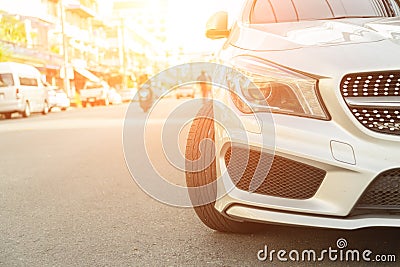 Silver car parked neatly inside an outdoor parking lot Stock Photo