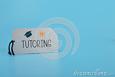 Silver card written with TUTORING. Tutoring provides a personalized and tailored approach to learning, helping students to Stock Photo