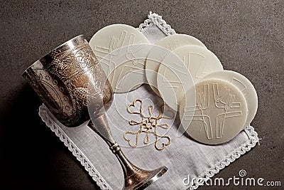 Silver chalice cup and Sacramental bread Stock Photo