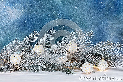 Silver christmas tree branch and decorative retro garland on blu Stock Photo