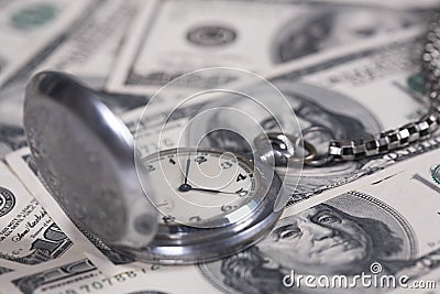 Silver clock and money Stock Photo