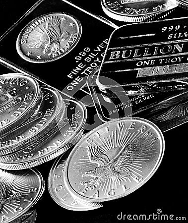 Silver Coins and Bars Representing Wealth Stock Photo