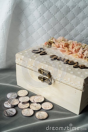 Silver coins and a box with the phrase yes, I do for a religious wedding celebration in Spain. Stock Photo