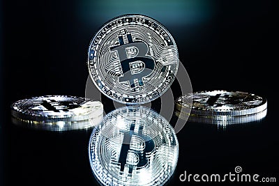 Silver colored bitcoin token with reflection Stock Photo