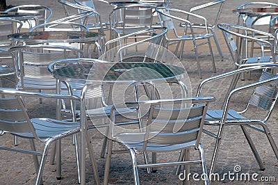 Silver coloured alluminium tables and chairs outside a cafe Stock Photo