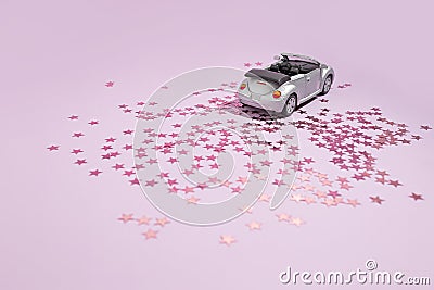 Silver convertible car goes on holiday on a purple background. Valentine celebration and delivery concept Stock Photo