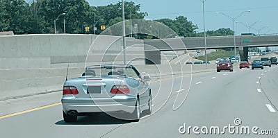 Silver convertible on the road Stock Photo