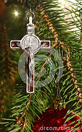 Body of Christ on real evergreen tree decorated with red bulbs Stock Photo