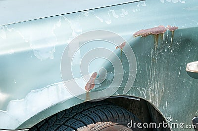 Silver damaged and broken car with dented aluminum metal body scratched and peeling paint from crash accident or collision Stock Photo