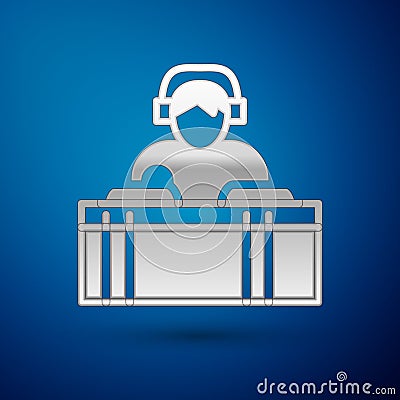 Silver DJ wearing headphones in front of record decks icon isolated on blue background. DJ playing music. Vector Vector Illustration