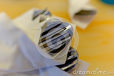 Silver eating utensils sit on a colorful table top at a local restaurant Stock Photo