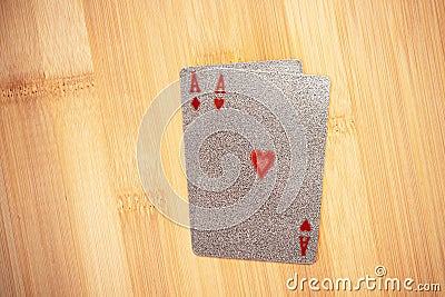 Silver embossed playing cards on the bamboo background. Stock Photo