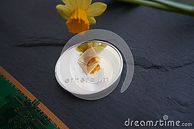 Silver Ethereum coin lying on theon a gray stone surface Editorial Stock Photo