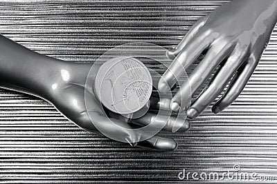 Silver euro coins in futuristic robot hands Stock Photo