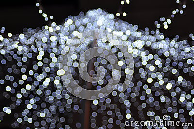 Silver festive glitter background with defocused lights. Stock Photo