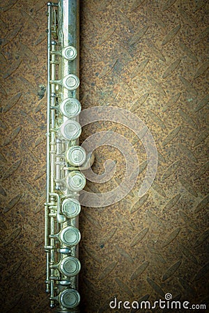 Silver flute with old steel background Stock Photo