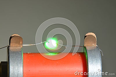 Silver fuse wire with 0,3mm diameter blows with a spark. Stock Photo