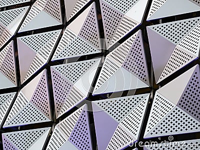 Silver geometric steel cladding with angular patterns Stock Photo