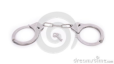 Silver handcuffs and a key on a white background Stock Photo