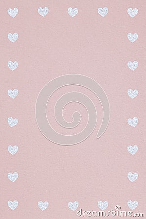 Silver heart patterned frame on a dull pink background Stock Photo