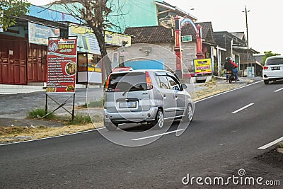 Silver Hyundai Atoz compact car driving fast on the road at afternoon Editorial Stock Photo