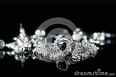 Silver jewelry ear rings, chain, rings close up shot Stock Photo
