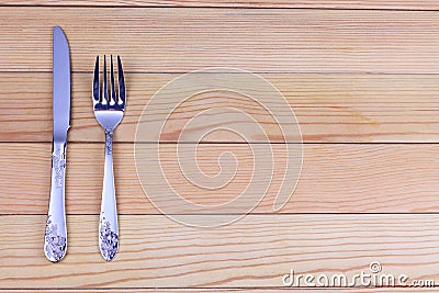 Silver knife and fork on wooden background. Cutlery on wooden board Stock Photo