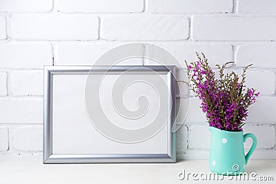 Silver landscape frame mockup with maroon purple flowers in mint Stock Photo