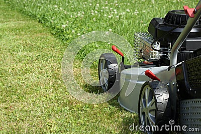 Silver lawn mower. Stock Photo