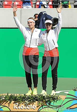 Silver medalists team Switzerland Timea Bacsinszky (L) and Martina Hingis during medal ceremony after doubles final Editorial Stock Photo