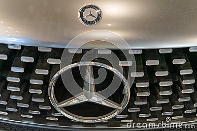 Silver Mercedes car. Bumper and headlights. Logo emblem on the hood. Warsaw, Poland - 28.07.2023. Editorial Stock Photo