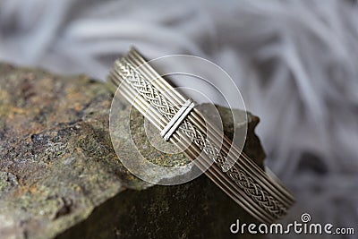 metal wire elegant bracelet on rocky background Stock Photo