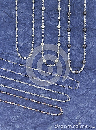 Silver necklaces over a blue background Stock Photo