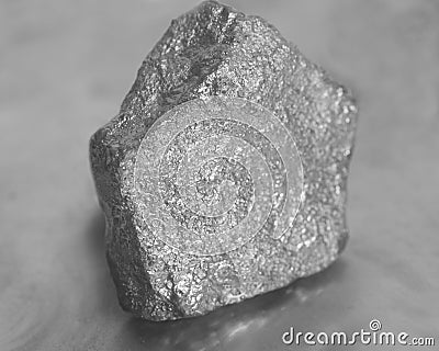 Silver nugget on gray background Stock Photo