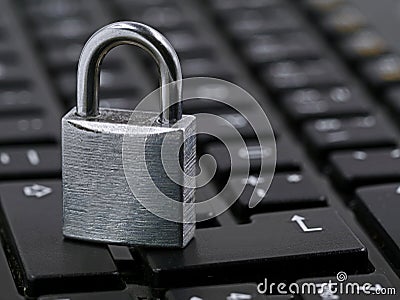 Silver padlock on black computer keyboard, close up Stock Photo