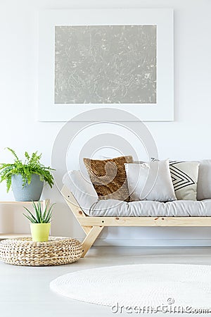 Silver painting above grey settee Stock Photo