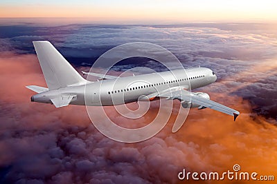 Silver passenger plane flies away. The plane flies over the pink sunset clouds. Rear view of aircraft Stock Photo