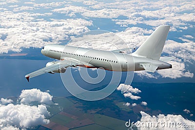 Silver passenger plane flies high above the clouds. Back view of aircraft Stock Photo