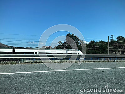 Silver passenger train moving to the right. Stock Photo