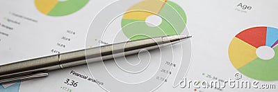 Silver pen lying at colorful financial graph Stock Photo