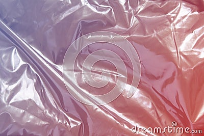 Silver shiny metal background, with neon pink gradient color. Glitter grey, thin sheet foil texture with uneven surface Stock Photo