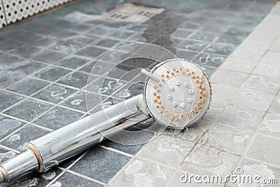 Silver shower head with limescales. Shower damaged from water scale Stock Photo