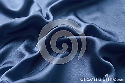 Silver silk background with a folds. Abstract texture of rippled silk surface Stock Photo