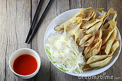 SILVER SILLAGO or Sillaginidae fish of fried in dish on wooden f Stock Photo