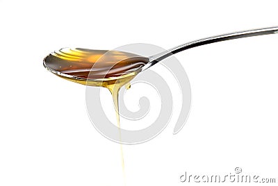 Silver spoon with golden honey Stock Photo