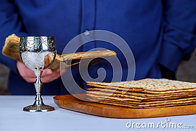 Silver wine cup with matzah, Jewish symbols for the Passover Pesach holiday. Passover concept. Stock Photo