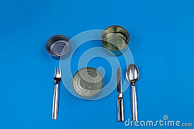 Silverware knife fork spoon napkin cans empty closed on yellow, cutlery. Stock Photo