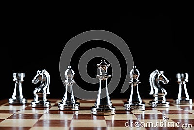 Silvery chess figures standing on chessboard Stock Photo