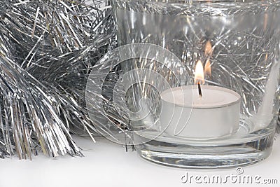 Silvery Tinsel and Candle Stock Photo