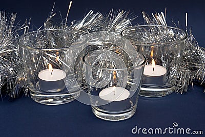 Silvery Tinsel and Three Candles Stock Photo
